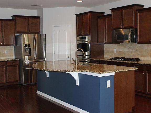 All GE Profile appliances, granite countertops, 5 burner stove.