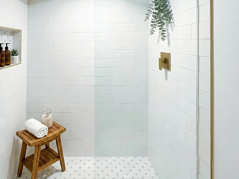 Modern bathroom with walk-in shower, glass enclosure, and clean tile finishes.