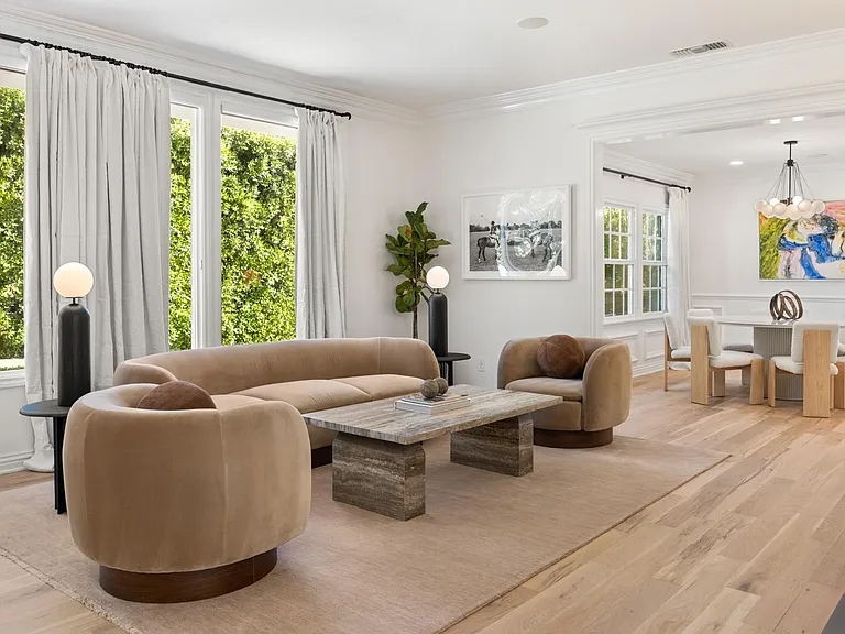 Revel in the stylish ambiance of the Living Room, featuring large open windows that invite natural light and warmth into this luxurious space.