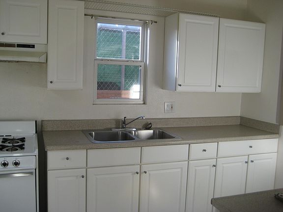 Full kitchen & gas stove, white cabinets with lots of storage.