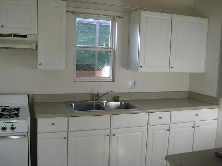 Full kitchen & gas stove, white cabinets with lots of storage.