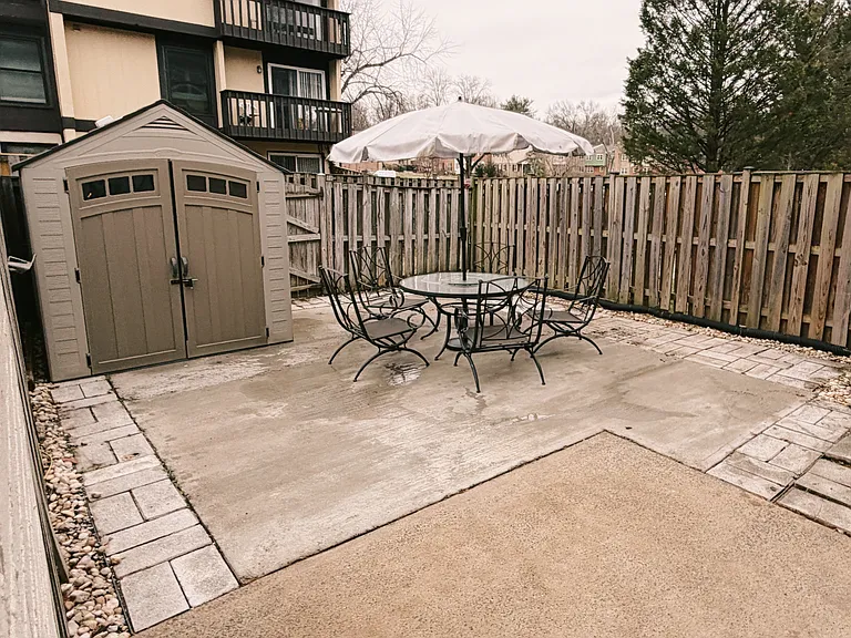 Hardscaped and full fence backyard. (patio furniture staging only)