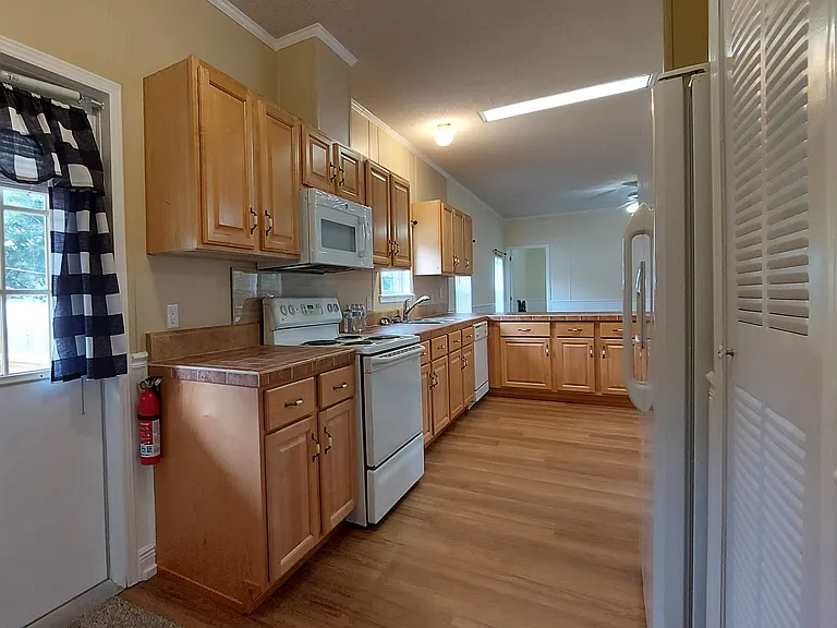 The back door entrance brings you right into the kitchen counter and refrigerator for depositing your groceries!