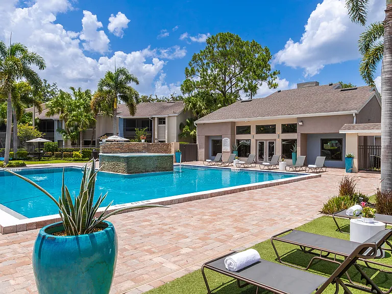 Dive into comfort at Harper Grand's expansive pool areaperfect complete with lounge chairs, lush landscaping, and a tranquil water feature.