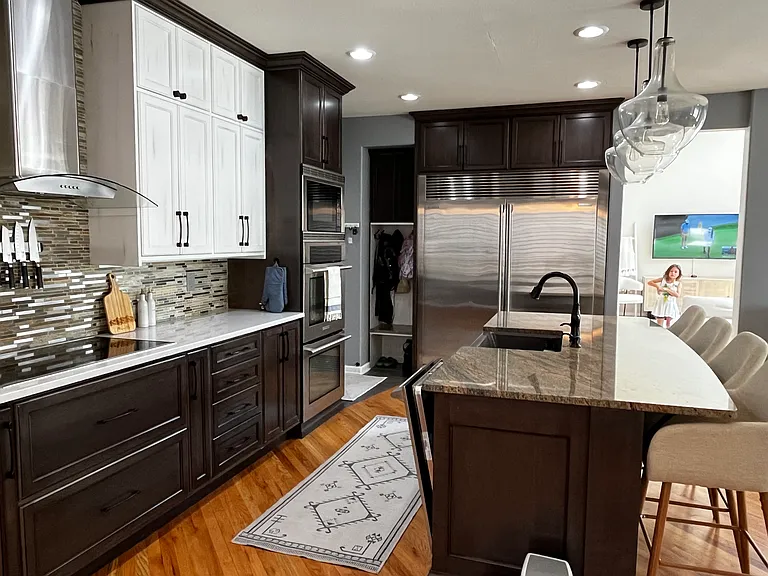 A true chef's kitchen with Electrolux Icon double oven's and microwave, Electrolux Icon built-in full-size freezer and refrigerator, Electrolux Icon flat top electric range w/hood, Kohler farmhouse sink and Moen Touch pull-down faucet.