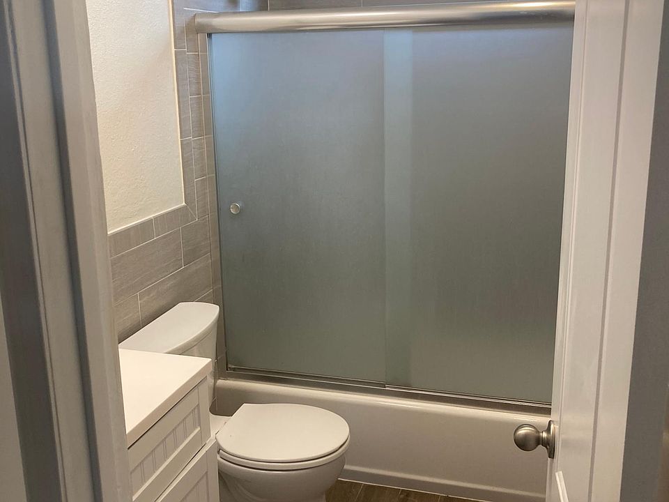 Bathroom with tile shower and new bathtub and fixtures