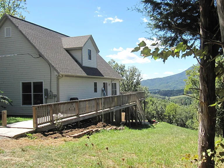 The exterior of the house showing the deck, which makes it wheelchair accessible.