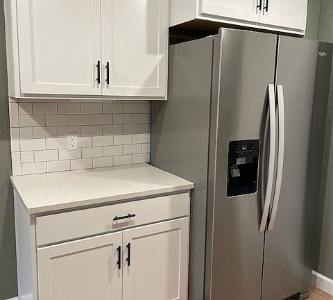 Kitchen features luxury vinyl plank, stainless steel appliances and quartz countertops