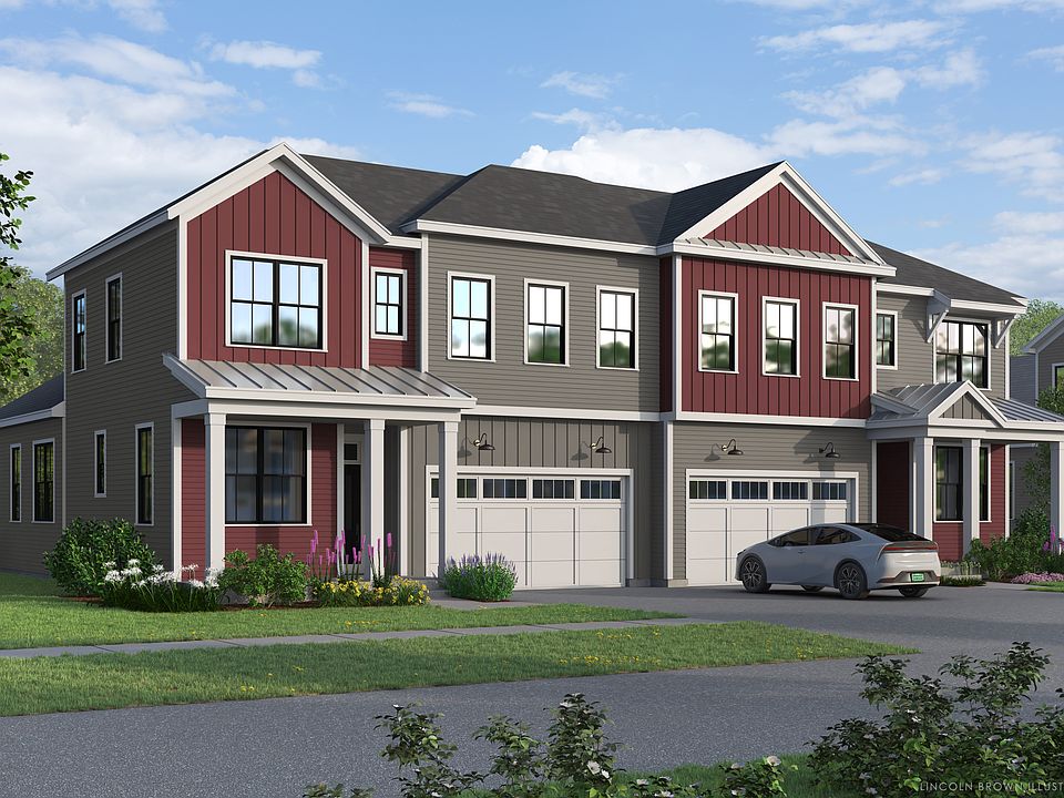 Modern two-story paired villa in The Annex with red and gray siding, large windows, two garages, and