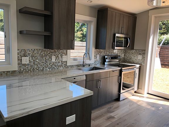 Kitchen left side with sink, stove, and microwave