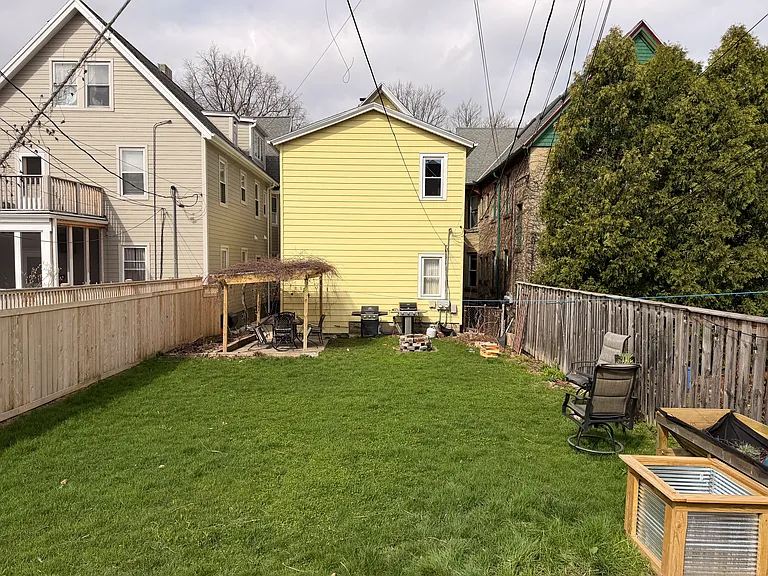 The backyard is perfect for gardens, relaxation, and dinners outside.