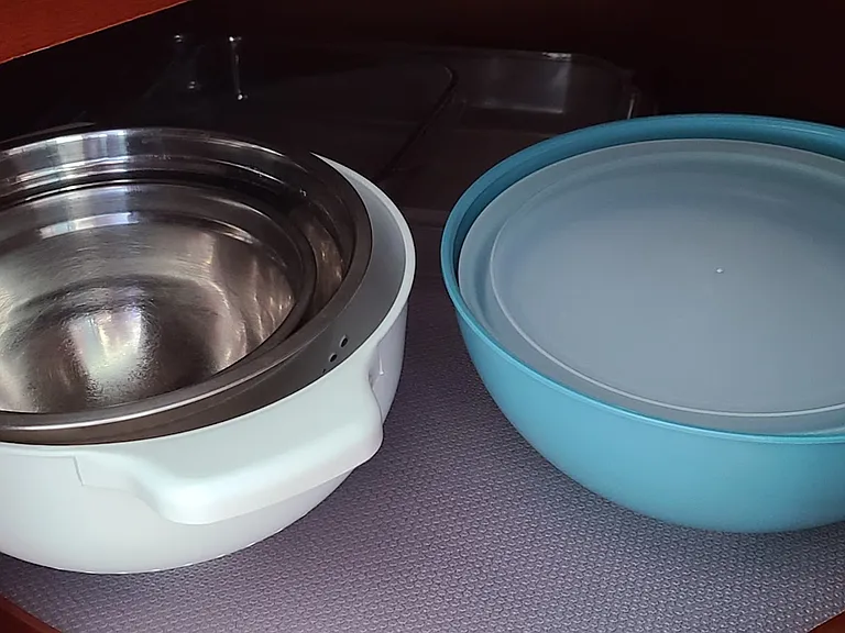 Kitchen bowls, colander, and baking pans.