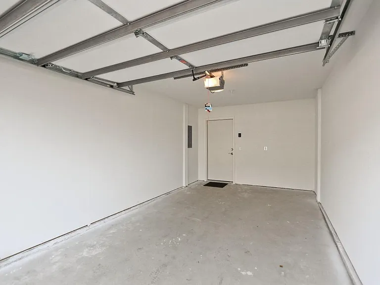 Private sheetrocked and painted garage with opener and keyless entry