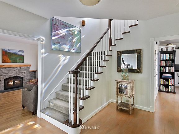 Elegant staircase leads to upper level bedroom suites