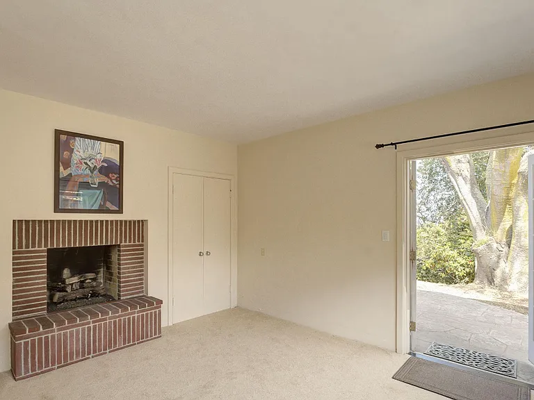 Bedroom #3 - Currently Unfurnished. Patio Access. (Fireplace is decorative only)