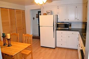 Once inside you enter into the kitchen area.  Plenty of updates in this space.  New laminate flooring, light fixtures, counter tops and appliances.  Ample work space and plenty of storage.