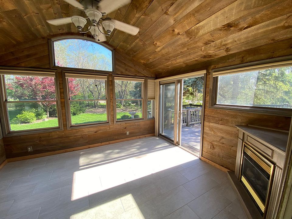 Sunroom connecting from the kitchen to deck, plus electric fireplace