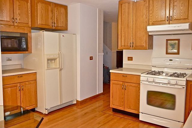 Remodeled kitchen has lots of cabinets plus pantry