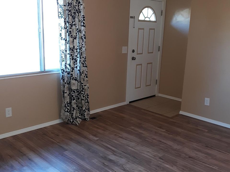 Living room with laminate flooring. New front door, large front window lets in lots of light and a great view of the mountains.