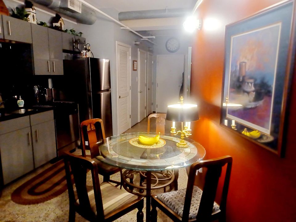 Kitchen Area With Built In Pantry and Beautiful Art