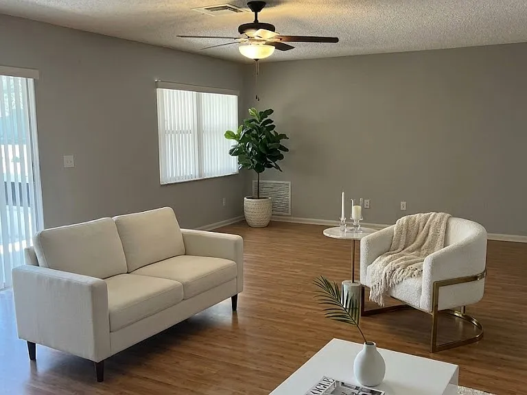 The open living and dining area is perfect for entertaining, and the kitchen offers ample cabinet space.