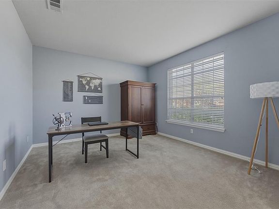 Office space OR Formal Living Room featuring light colored carpet and baseboards