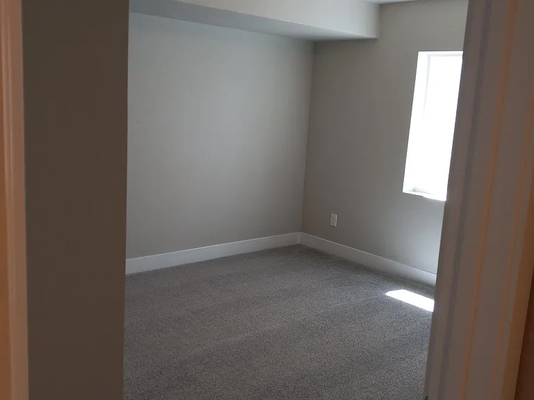Bedroom 4, also with large window and closet.