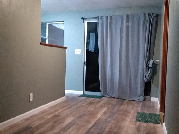 Dining area with kitchen to the left and entrance to backyard.