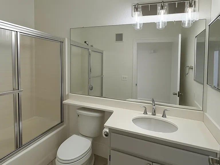 Bathroom has convenient tub/shower combo.