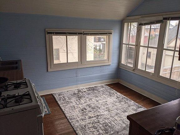 Eat-in kitchen looks out to the private back yard. Before new floors.