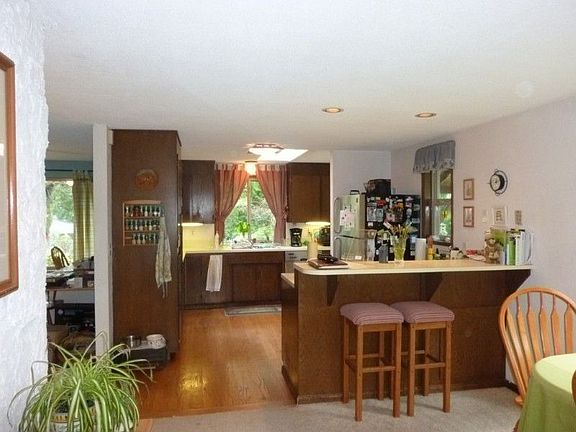 View from the family room into the kitchen showing the breakfast bar.