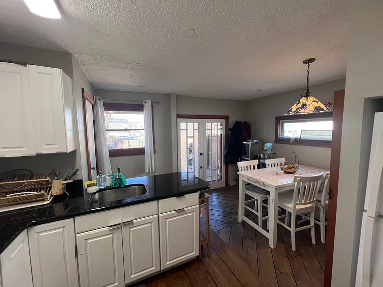 Kitchen w/ eat-in area & powder room.