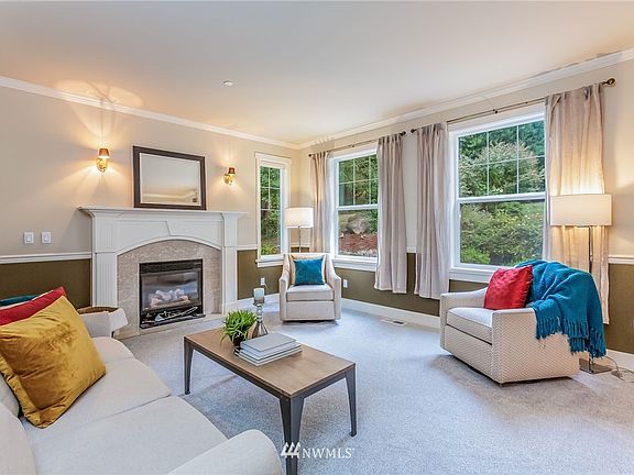 Stepping inside, you will find a two-story entrance with a formal living room, anchored by a gas fireplace