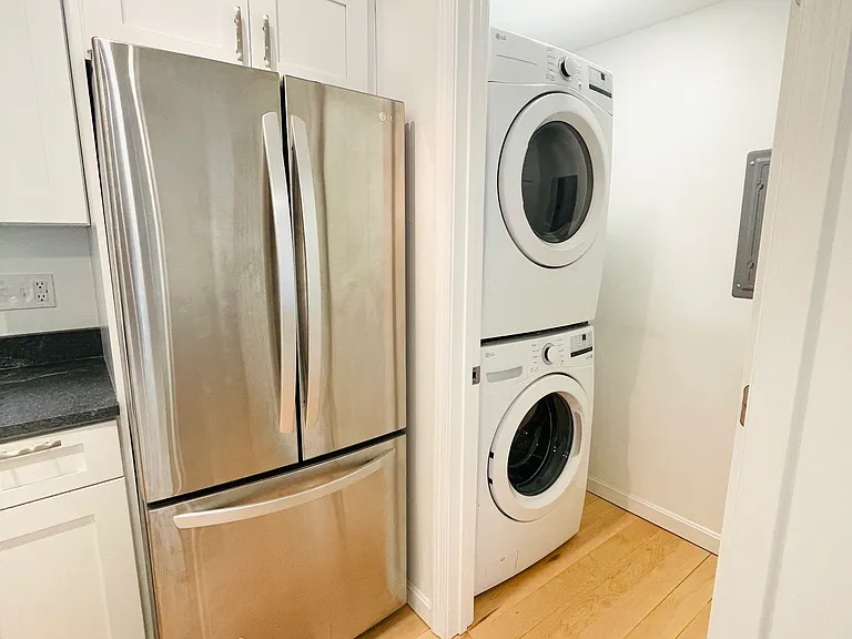 Kitchen and Laun dry room: Stainless steel fridge and freezer, full sized washer and gas dryer, ironing board and iron