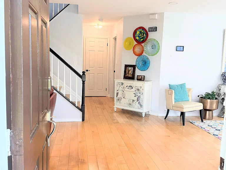The main level - living room, family room, dining area, kitchen, powder room, coat closet, under-stairs storage, and laundry room connecting the garage.