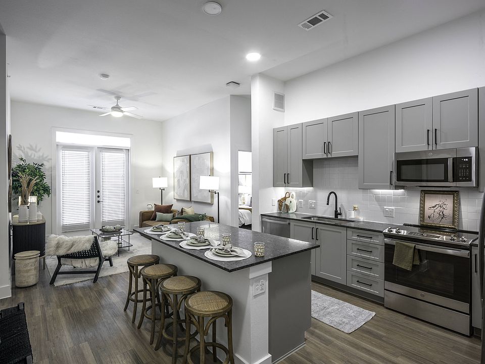 Upgrade your culinary space with stunning granite countertops and a spacious kitchen island, perfect for both style and functionality.