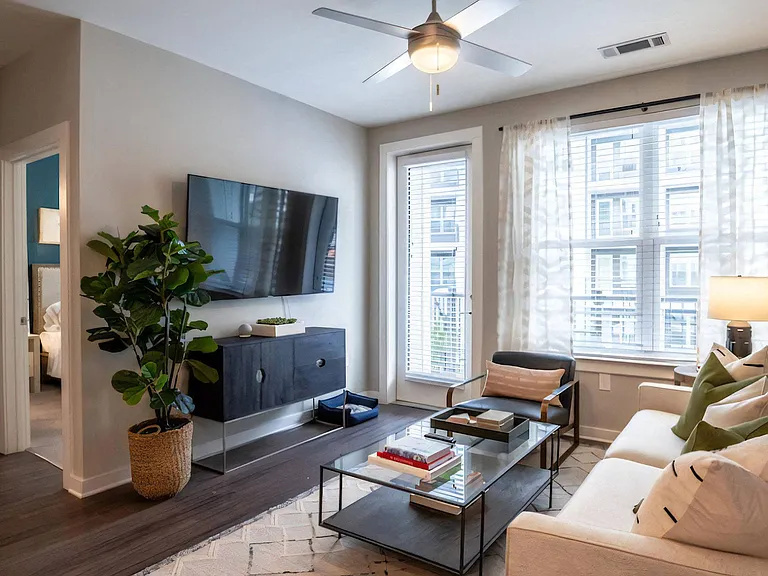 Apartment Interior Featuring Couch, Coffee Table, and Wall-Mounted TV