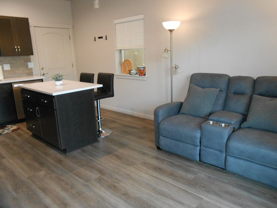 All laminate wood flooring for ease in cleaning. (Furnishings NOT included.)