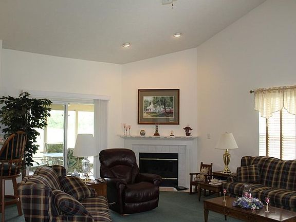 Open great room with vaulted ceiling. Corner set gar fireplace. Entry door to rear screened porch