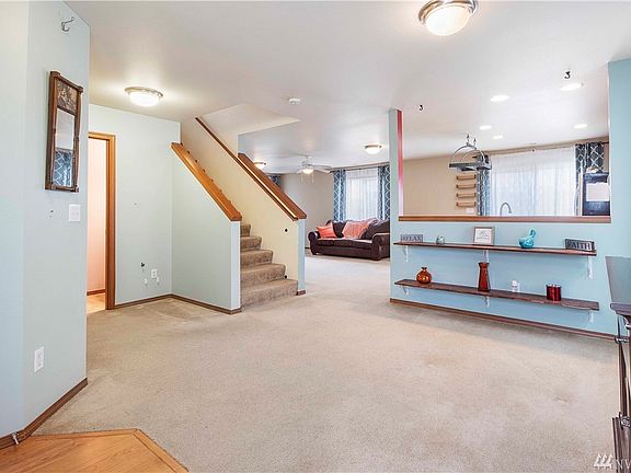 Half bath with closet on left. Dining and kitchen ahead