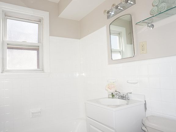 Two Bed with Hardwood Floors - Bath: refinished tub/shower with vanity, medicine cabinet, hallway linen closet with door mirror