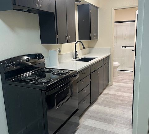 Kitchen with new appliances, quarts countertop, stainless steel sink.