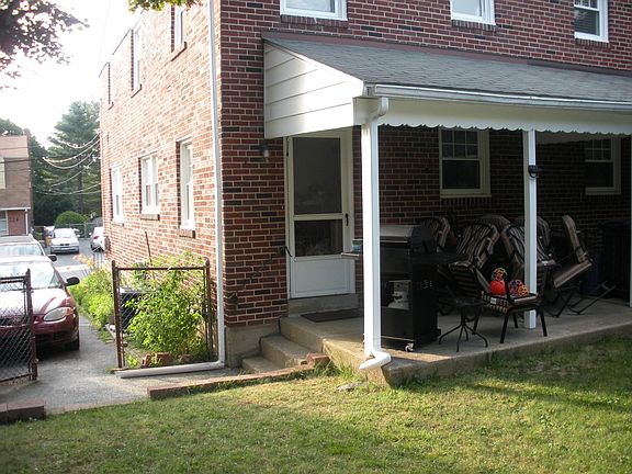 covered back patio with space for table and chairs, grill, etc
