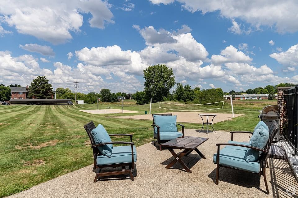 Photo of the clubhouse grounds, with seating an volleyball courts