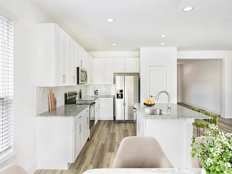 Bright cabinetry and sleek finishes in our Single Family Homes define this Amavi Celina kitchen, designed for effortless living with style and functionality.