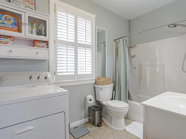 Primary Bathroom attached to bedroom, also where the laundry is located
