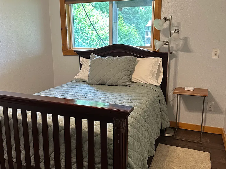 Basement bedroom with a full-size bed.