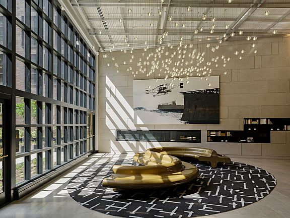 Well appointed resident clubroom with floor to ceiling windows