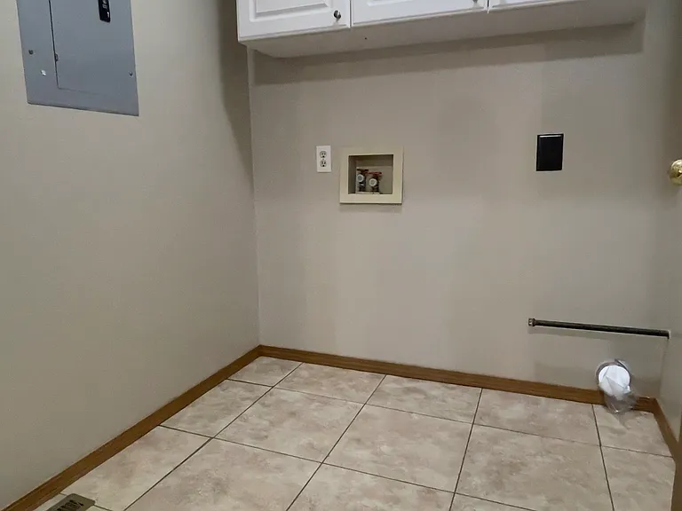 Laundry Room with Full Hook-ups ready for your Washer and Dryer with lots of Storage Cabinets above