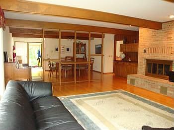 The living room and dining room are separated by an architectural wall that keeps this floor plan open and flowing.